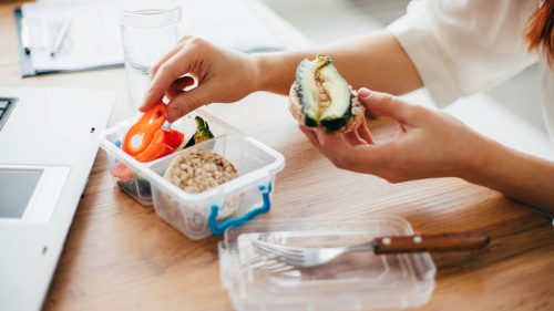 Add an image of a person packing healthy snacks in containers - FitnessPal